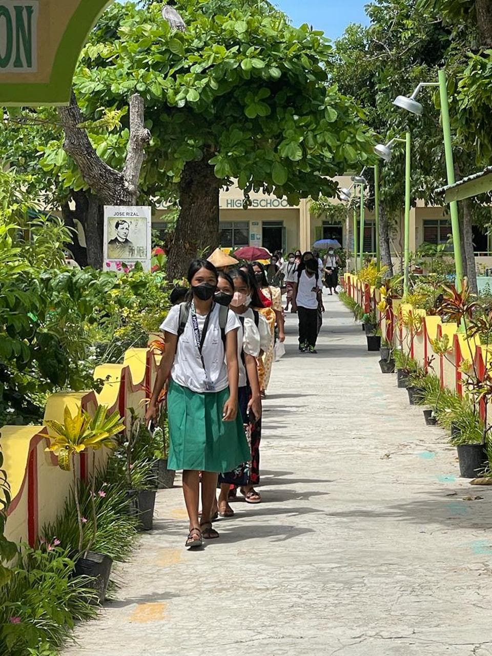 A group of children walking to Manamoc Elementary School